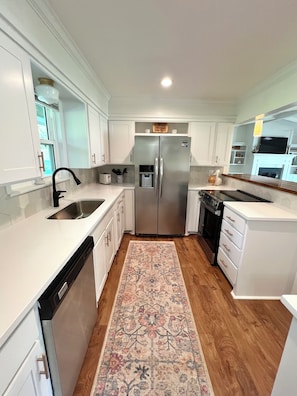 Updated kitchen with stainless appliances and basic cookware.