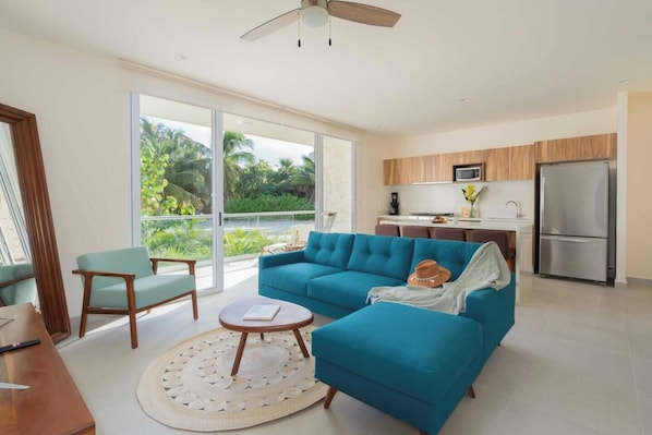 Unwind in our inviting living room, featuring a plush couch, sleek smart TV, and refreshing AC. Step out onto your private patio to enjoy the ocean breeze and relax in your very own hot tub.