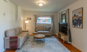 Cozy living room infused with soft textures, warm wood accents, and tranquil vibes.