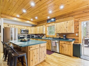 Fully stocked kitchen with large island for cooking, eating, or entertaining. 
