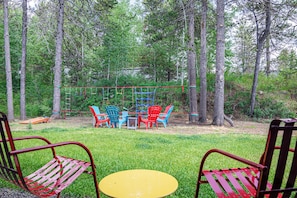 Backyard with a fire pit and kids' climbing wall