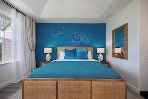 Large and comfy king bed, tropical-inspired decor, and soft natural light for ultimate relaxation