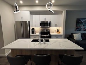 Fully stocked kitchen. Dining area on peninsula.