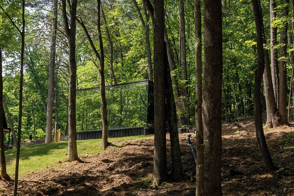 Surrounded by towering trees and total tranquility—this mirrored retreat offers couples a one-of-a-kind escape into the heart of the woods.