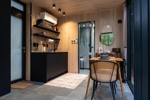 Thoughtfully designed for comfort and connection—enjoy intimate dinners, morning coffee, and wooded views all in one cozy, light-filled space.