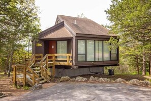 Welcome to Treetop Village Unit 106 – Your peaceful Ozarks retreat nestled in a wooded hillside setting, just moments from lake fun and resort amenities!
