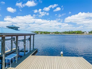 Enjoy the expansive vistas of the bayou from the private dock, ideal for relaxing and taking in the serene surroundings.