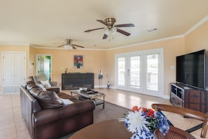 Stylishly decorated, the spacious living area features beach-inspired accents and ample seating, leading to the waterfront deck.