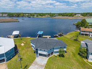 Aerial views reveal the stunning bayoufront location, complete with a private dock and ample space for outdoor activities.