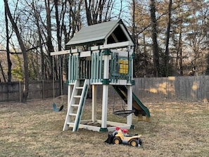 Playground for the kids is conveniently located right beside the front porch and grill, all within the fence.