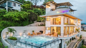 Evenings shine with the infinity pool, hot tub, and panoramic ocean views