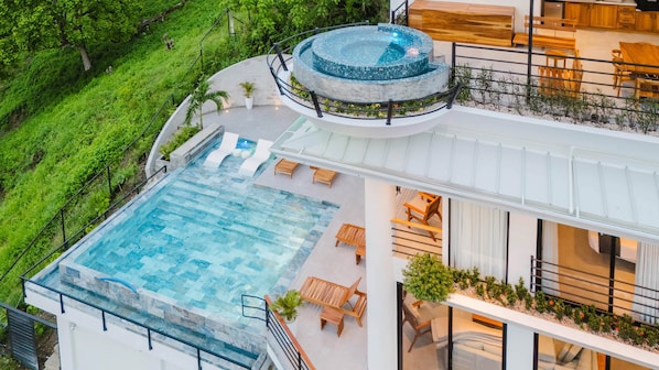 Casa Vistas Infinitas—ocean views, open-air living, and a glowing infinity pool.