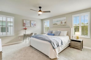 Peaceful primary bedroom with natural light and soft, comfy bedding