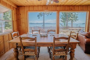 Gather around the dining table for six, set beside windows showcasing lake views
