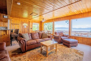 Soaring windows bring in natural light and showcase beautiful lake views