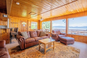Soaring windows bring in natural light and showcase beautiful lake views