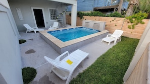 Pool view with staircase to the 2nd floor and entrance to the extra open space