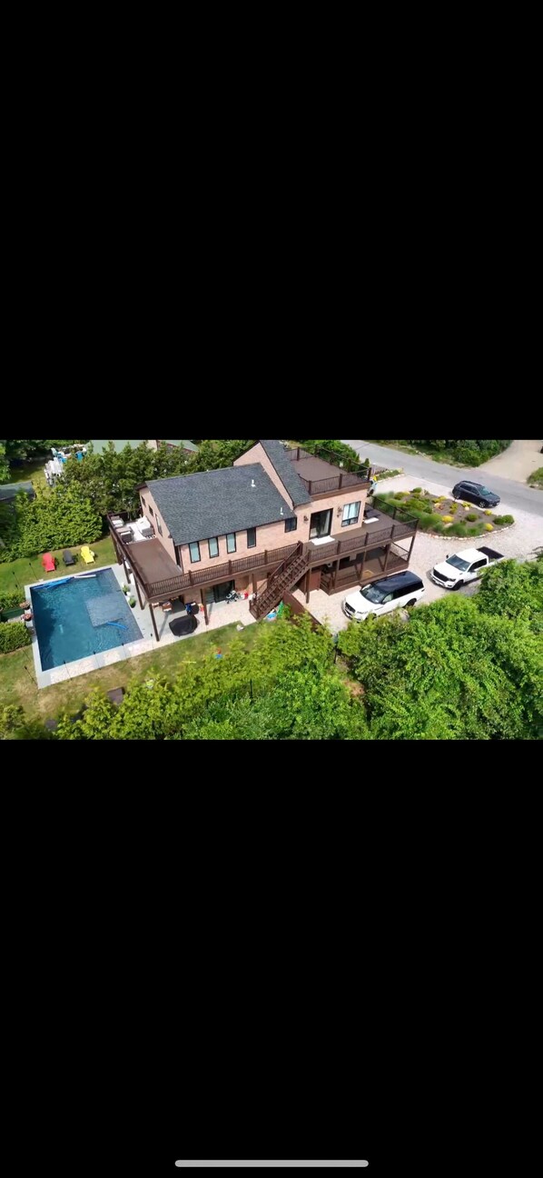 Drone shot ! Side of house with double deck balcony ! Backyard view with pool !
