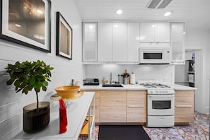 Modern kitchen with character and charm—fully functional and stocked with all the basics you’ll need for your stay