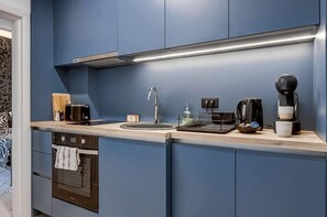 Cook up happiness in this sleek blue kitchen – check availability!