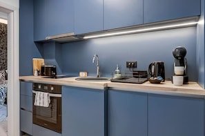 Cook up happiness in this sleek blue kitchen – check availability!