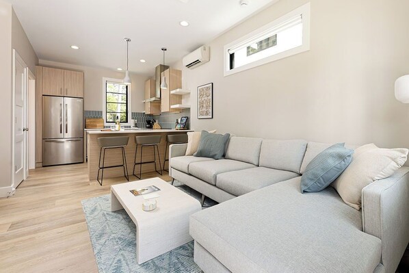 Enjoy your downtime in this beautifully furnished living room, complete with a large smart TV, plush seating, and a modern aesthetic. The space is bright, airy, and designed for comfort and entertainment.