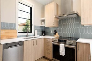 Cook like a pro in this fully equipped kitchen, complete with top-of-the-line stainless steel appliances, sleek cabinets, and a tasteful backsplash—perfect for everyday meals or entertaining guests.