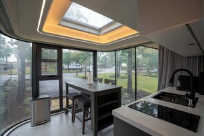 A Modern kitchen area with ample lighting and views!

