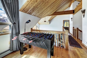 Loft with full size sleeper sofa and foosball table