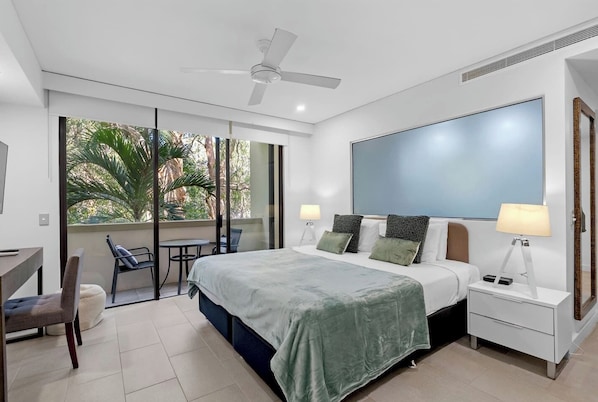Wake up to the gentle sway of palm trees from the king bed, and let the natural light spill in as you step onto your private, leafy balcony.