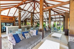Enjoy a cool drink and unwind beneath soaring timber beams in the shared area—perfect for lazy afternoons or social evenings.