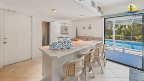 Ground floor wet bar with pool view.