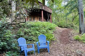 Adirondak chairs by the creek and mulch path going up.  Please stay on the path