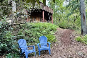 Adirondak chairs by the creek and mulch path going up. Please stay on the path
