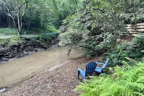 Adirondak chairs by the creek.