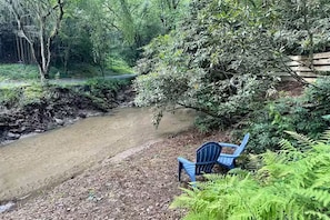Adirondak chairs by the creek.