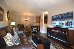 Living Room with large flat screen TV and electric fireplace