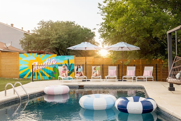 This backyard feels like a private oasis ready for an afternoon of lounging and swimming!