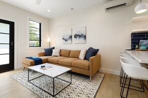 Relax in this cozy living room with a smart TV, perfect for streaming your favorite shows.