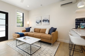 Relax in this cozy living room with a smart TV, perfect for streaming your favorite shows.