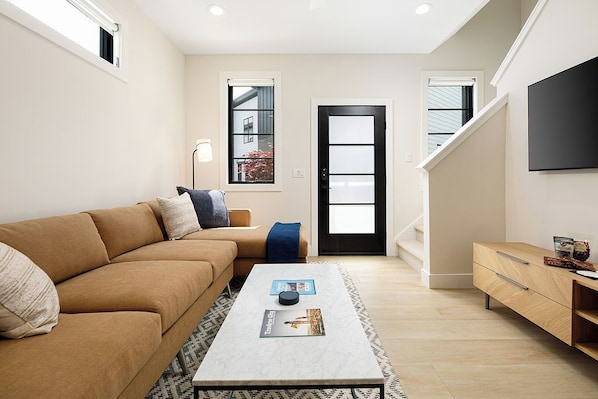 Bright and inviting living space with a smart TV, ideal for movie nights or lazy afternoons.
