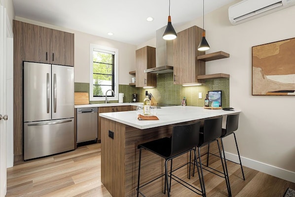 Cook with ease in this stylish kitchen featuring modern appliances and warm wood cabinetry.