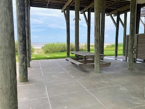 Shaded picnic table under the house with an unbeatable ocean breeze.