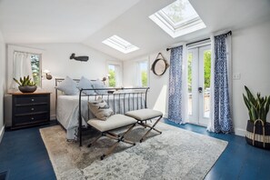 The primary bedroom with a queen bed! The primary has access to the deck via the french doors. The doors do lock. Clean linens provided.
