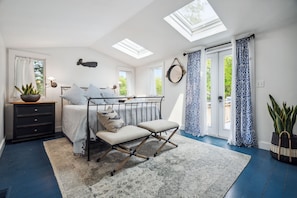 The primary bedroom with a queen bed! The primary has access to the deck via the french doors. The doors do lock. Clean linens provided.