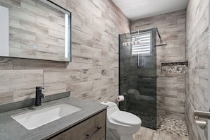 Luxurious bathroom featuring stunning wood-look tile throughout.