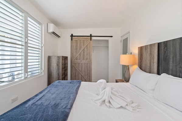 Serene bedroom with a comfortable king-size bed and charming barn door closet.