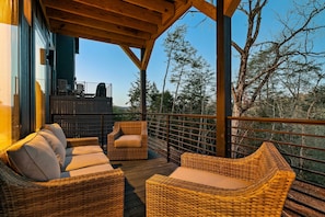 Relax on the spacious deck with stunning tree-top views and comfortable seating!