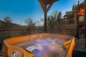 Unwind under the stars in your private hot tub with stunning mountain views!