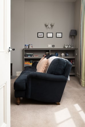 Cambridge House - unwind on the sofa in front of the modern wood burner after a busy day exploring Holy Island